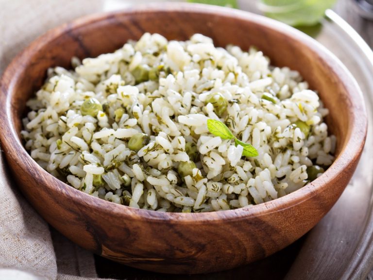Mediterranean rice with greens and in a wooden bowl